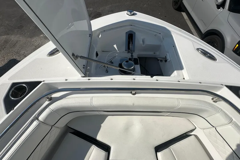 Slide: The Image of 2021 Blackfin 252 DC boat interior with open storage compartment and seating area. - 22