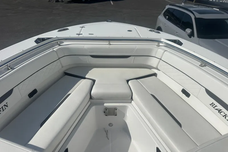 Slide: The Image of 2021 Blackfin 252 DC boat interior with white cushioned seating and sleek design. - 24