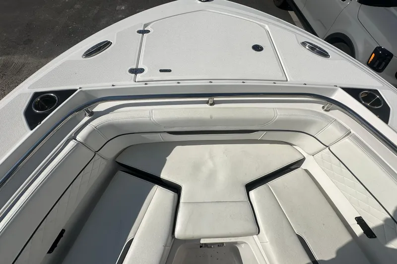 Slide: The Image of 2021 Blackfin 252 DC boat interior with white cushioned seating and stainless steel accents. - 4