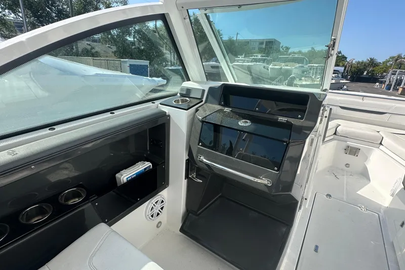 Slide: The Image of 2021 Blackfin 252 DC boat interior with helm station and seating area. - 6