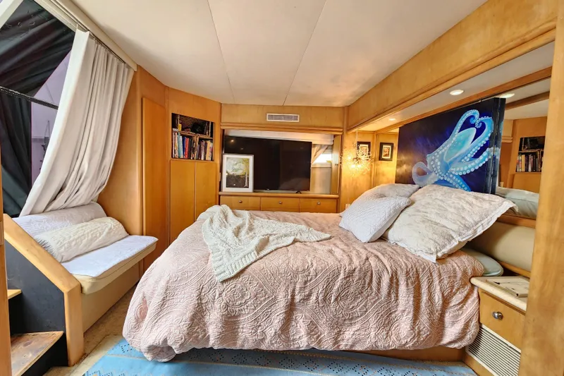 Slide: The Image of Luxurious bedroom in a 1997 Carver 500 Cockpit Motor Yacht with elegant decor. - 10