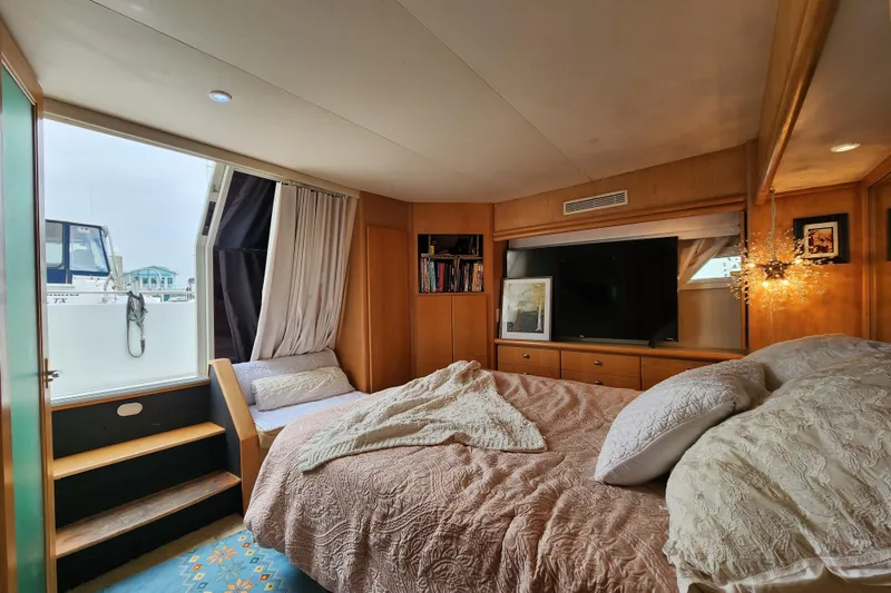 Slide: The Image of Luxurious bedroom interior of a 1997 Carver 500 Cockpit Motor Yacht with elegant decor. - 11