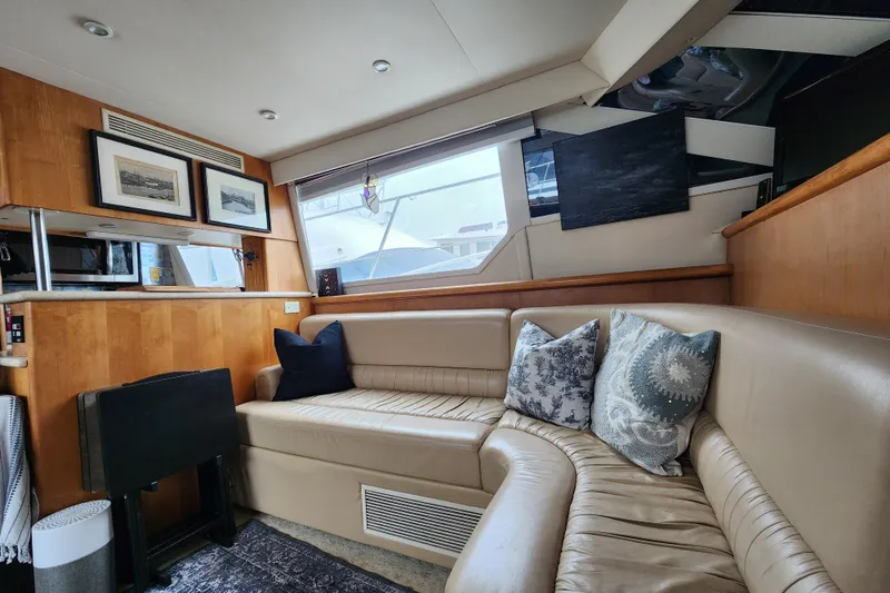 Slide: The Image of Luxurious interior of a 1997 Carver 500 Cockpit Motor Yacht with plush seating and decor. - 21