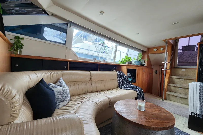 Slide: The Image of Luxurious interior of a 1997 Carver 500 Cockpit Motor Yacht with leather seating and wooden accents. - 22