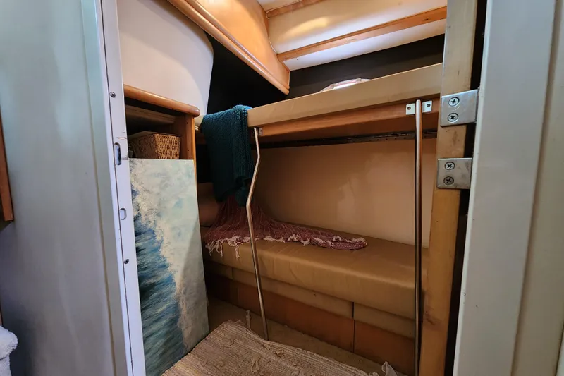 Slide: The Image of Interior of 1997 Carver 500 Cockpit Motor Yacht with cozy bunk beds and decor. - 23