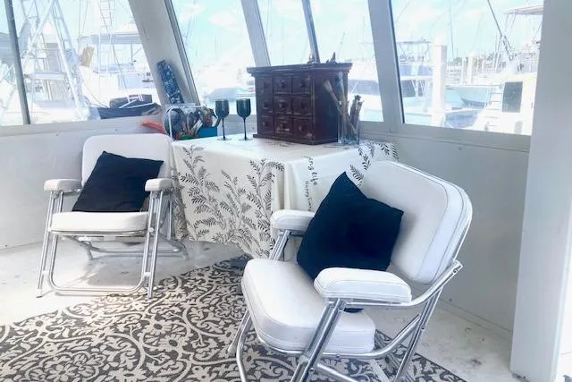 Slide: The Image of Interior of 1997 Carver 500 Cockpit Motor Yacht with chairs and decorative table. - 25