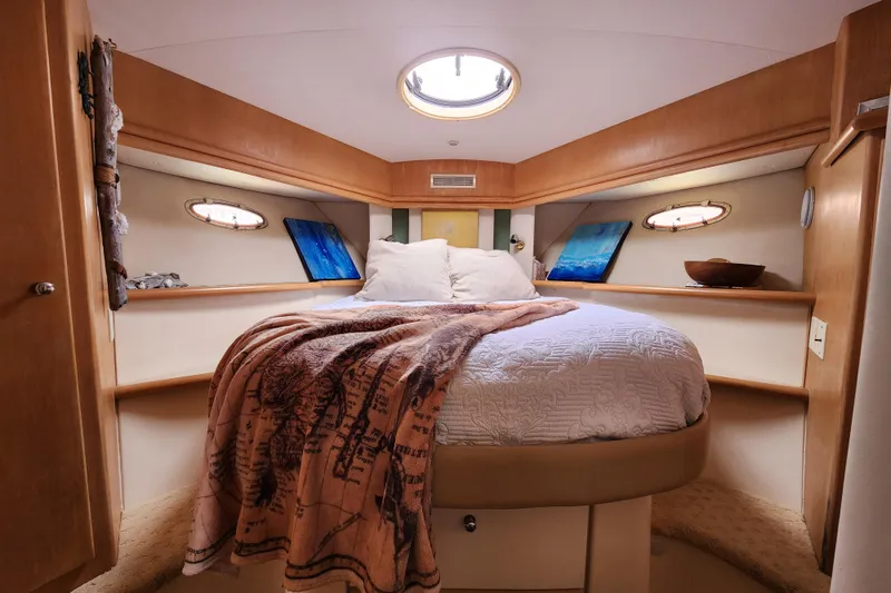 Slide: The Image of Cozy bedroom in 1997 Carver 500 Cockpit Motor Yacht with plush bedding and nautical decor. - 3