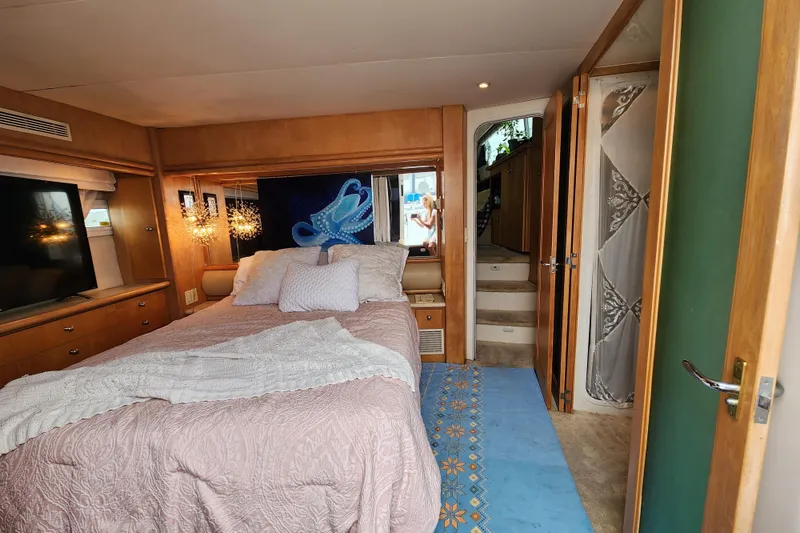 Slide: The Image of Luxurious bedroom interior of 1997 Carver 500 Cockpit Motor Yacht with cozy bedding. - 8