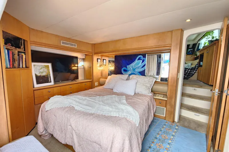 Slide: The Image of Luxurious bedroom in 1997 Carver 500 Cockpit Motor Yacht with cozy decor and artwork. - 9