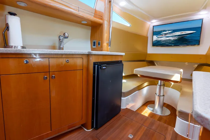 Slide: The Image of Interior of 2015 Intrepid 475 Panacea yacht with kitchenette and seating area. - 21