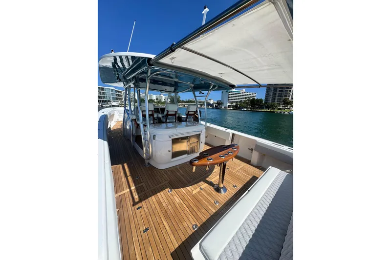 Slide: The Image of 2015 Intrepid 475 Panacea yacht with teak deck, spacious seating, and waterfront view. - 28