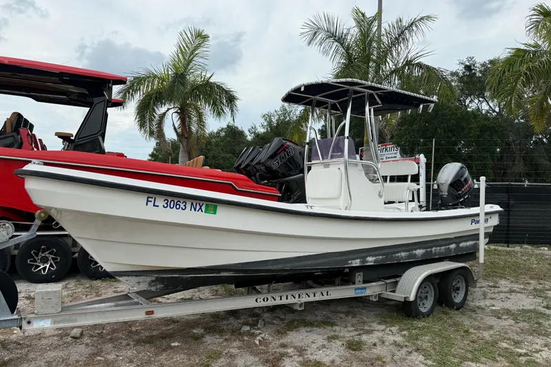 The Image of 2007 Panga 22LX boat on trailer, parked outdoors with palm trees in background. - 0