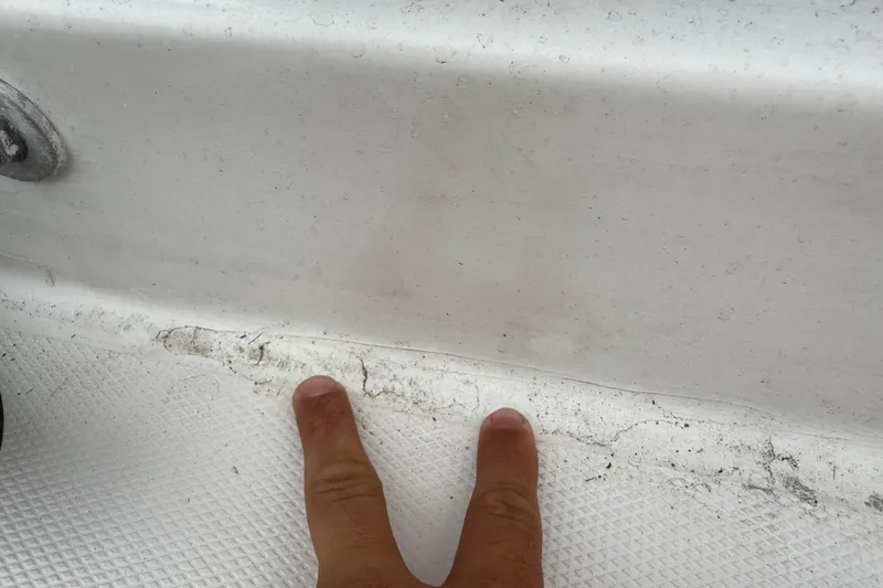 Slide: The Image of Close-up of a 2007 Panga 22LX boat surface with visible wear and dirt. - 16