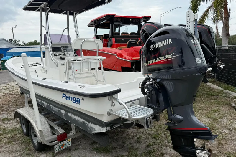 Slide: The Image of 2007 Panga 22LX boat with Yamaha VMAX engine on trailer, parked outdoors. - 2