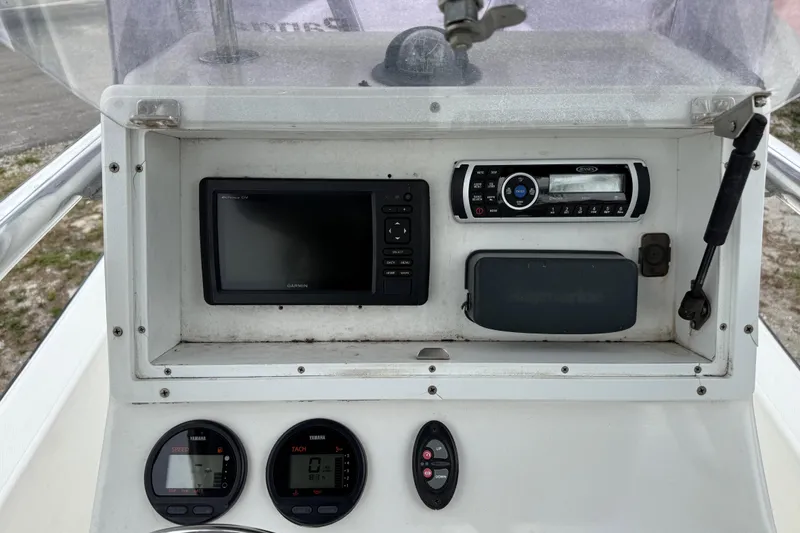 Slide: The Image of Console of a 2007 Panga 22LX boat featuring navigation and control instruments. - 21