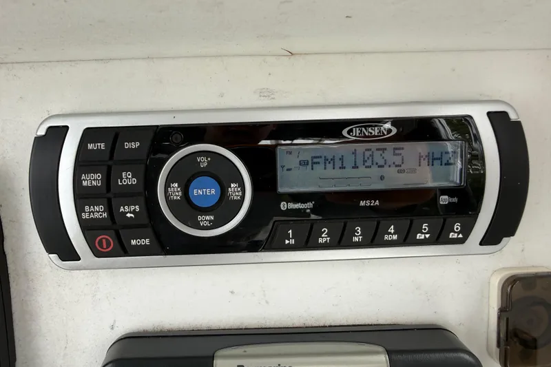 Slide: The Image of Jensen MS2A stereo system displaying FM 103.5 MHz in a 2007 Panga 22LX boat. - 24