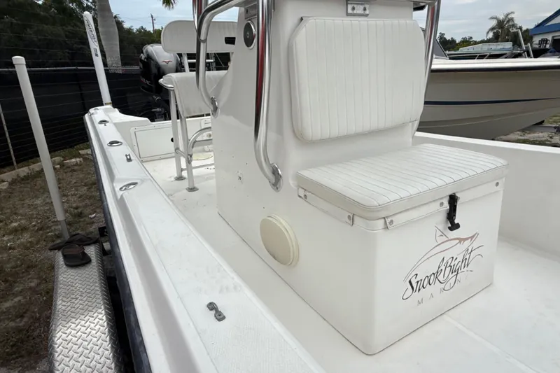 Slide: The Image of 2007 Panga 22LX boat interior with seating and storage, featuring "Snook Bight" branding. - 27