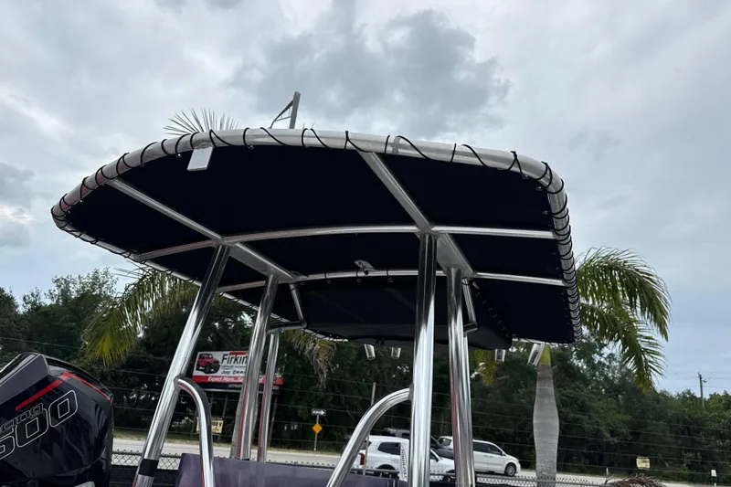 Slide: The Image of 2007 Panga 22LX boat with T-top canopy and palm trees in the background. - 30