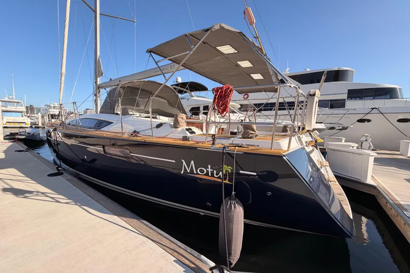 Slide: The Image of 2013 Jeanneau 57 yacht docked at marina under clear blue sky. - 11