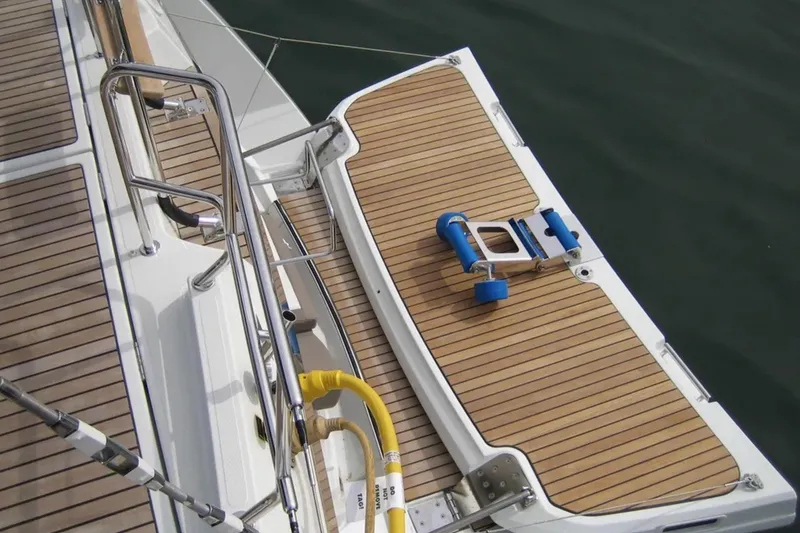 Slide: The Image of Jeanneau 57 yacht deck, 2013 model, featuring teak flooring and stainless steel railings. - 14