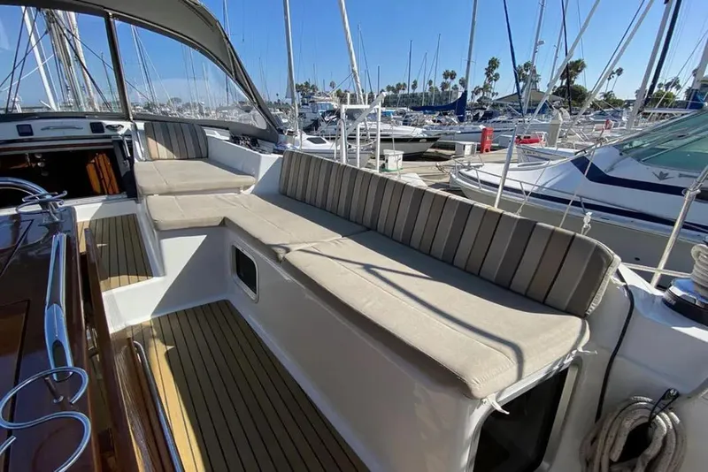 Slide: The Image of 2013 Jeanneau 57 yacht interior with cushioned seating, docked at marina. - 15