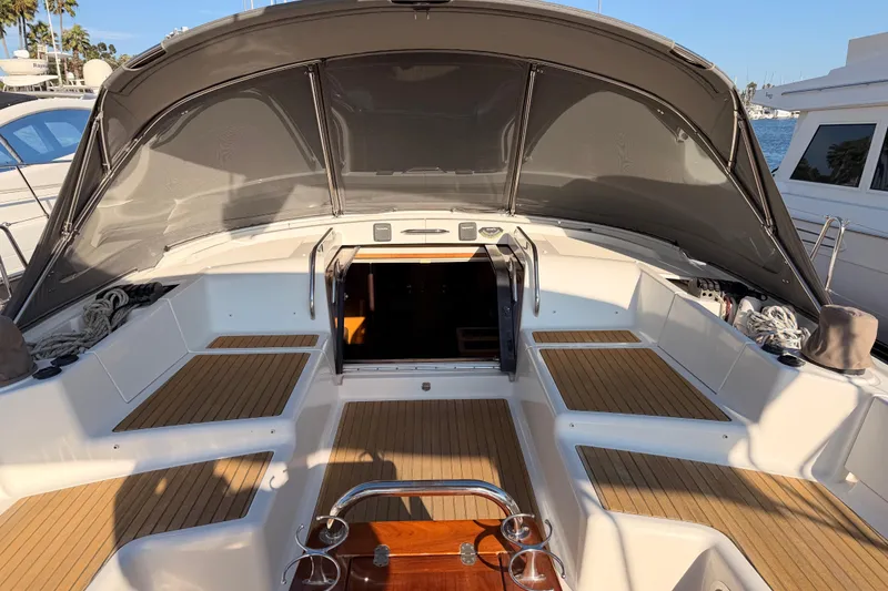 Slide: The Image of 2013 Jeanneau 57 yacht cockpit with teak flooring and sunshade canopy. - 23