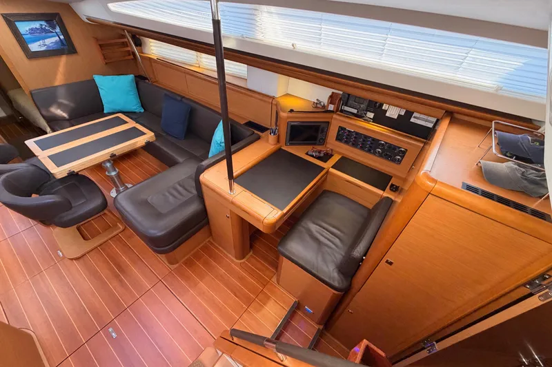 Slide: The Image of Luxurious interior of a 2013 Jeanneau 57 yacht with elegant wood finishes and seating. - 28