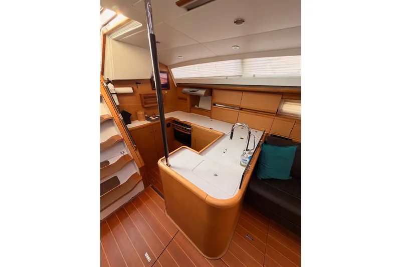 Slide: The Image of Luxurious interior of 2013 Jeanneau 57 yacht with modern kitchen and seating area. - 29