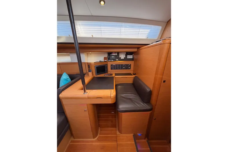 Slide: The Image of Interior of 2013 Jeanneau 57 yacht with navigation station and seating area. - 35