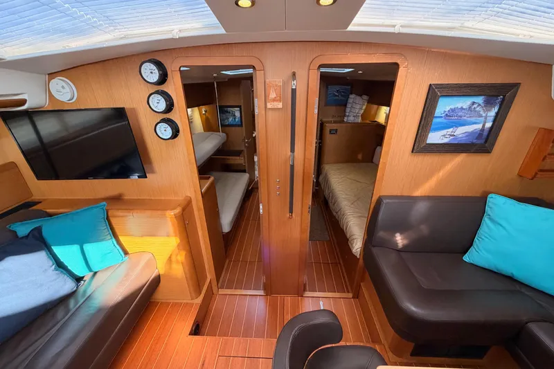 Slide: The Image of Interior of 2013 Jeanneau 57 yacht with cozy seating and elegant wood finish. - 38