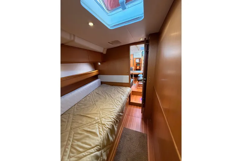 Slide: The Image of 2013 Jeanneau 57 yacht interior cabin with bed and skylight. - 42