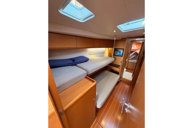 Slide: The Image of Interior of 2013 Jeanneau 57 yacht with cozy bunk beds and wooden finish. - 43