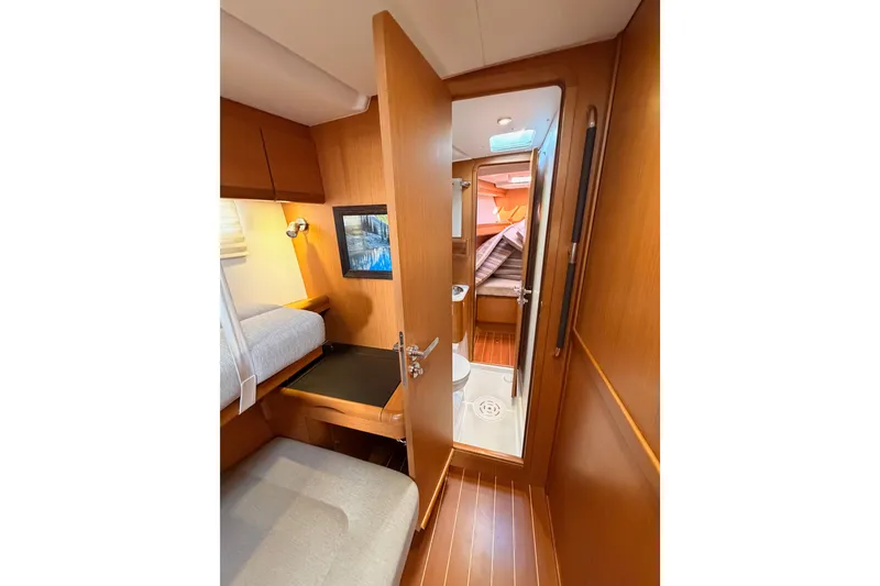Slide: The Image of 2013 Jeanneau 57 yacht interior with cozy cabin and wooden finishes. - 46