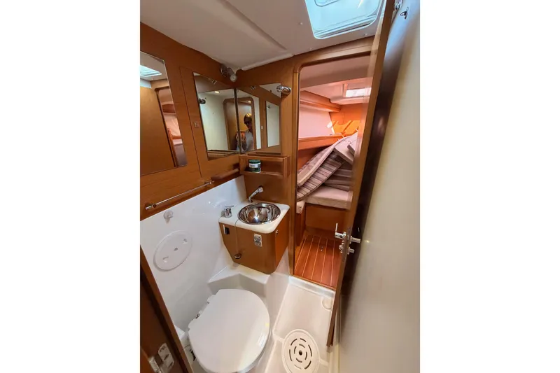 Slide: The Image of 2013 Jeanneau 57 yacht bathroom with wooden accents and compact design. - 47