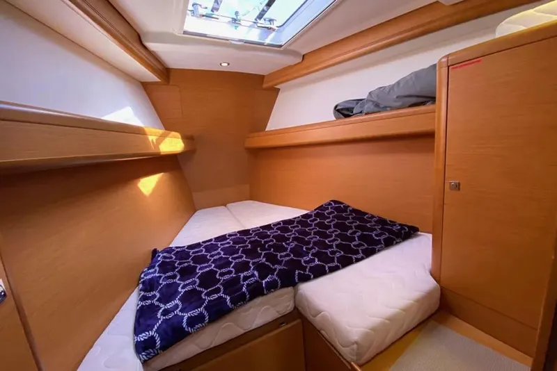 Slide: The Image of Cozy cabin interior of 2013 Jeanneau 57 yacht with skylight and wooden finish. - 48