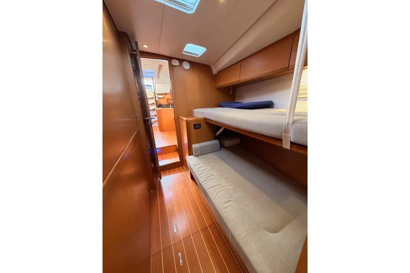 Slide: The Image of 2013 Jeanneau 57 yacht interior with wooden flooring and bunk beds. - 50
