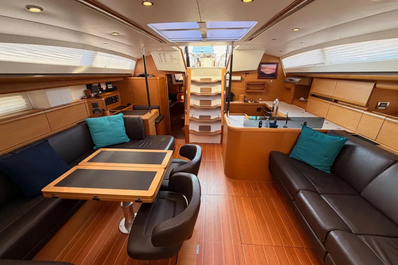 Slide: The Image of Luxurious interior of a 2013 Jeanneau 57 yacht with elegant wood finishes and modern amenities. - 51