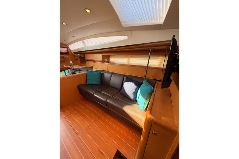 Slide: The Image of Luxurious interior of 2013 Jeanneau 57 yacht with leather seating and wooden finishes. - 54