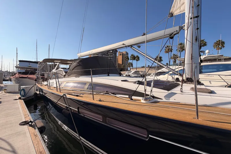 Slide: The Image of 2013 Jeanneau 57 yacht docked at marina under clear blue sky. - 8