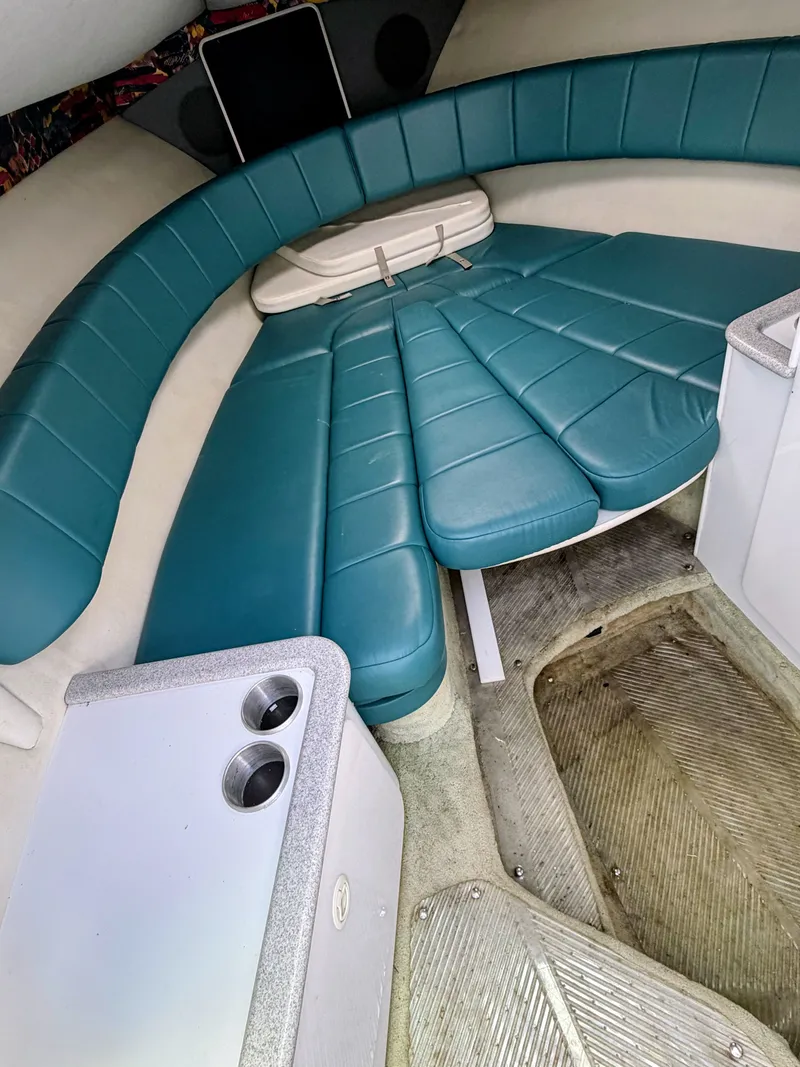 Slide: The Image of Interior of a boat with blue cushions and a table. - 10
