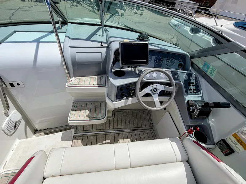 Slide: The Image of The cockpit of a boat with a steering wheel, instruments, and a monitor. - 3