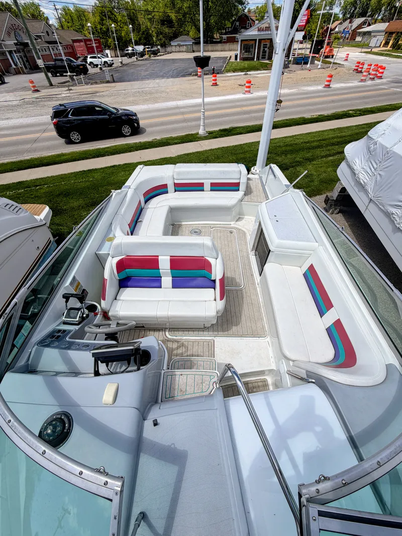 Slide: The Image of A boat with colorful seating is on land next to a road. - 8