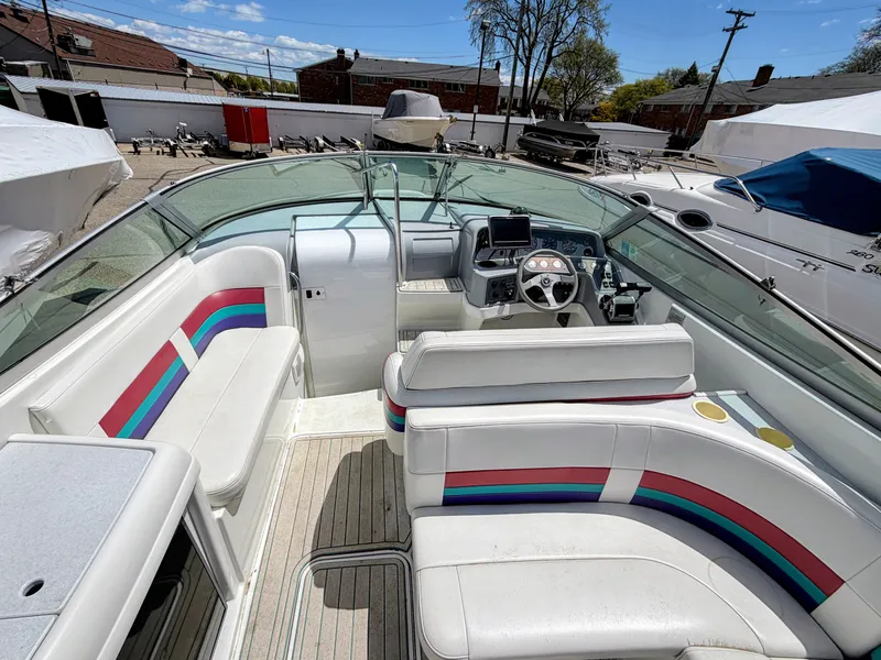 Slide: The Image of Interior view of a boat with white seats and colorful stripes, surrounded by other boats. - 9