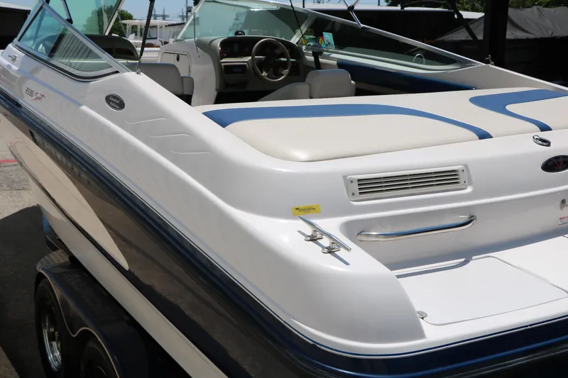 Slide: The Image of 1996 Chaparral 2330 SS boat, white and blue, parked on a trailer. - 10