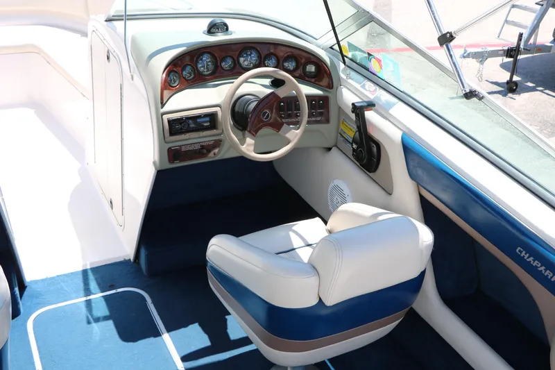 Slide: The Image of Interior of a 1996 Chaparral 2330 SS boat, featuring a sleek dashboard and steering wheel. - 15