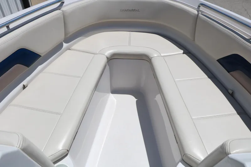 Slide: The Image of 1996 Chaparral 2330 SS boat interior with white cushioned seating. - 18