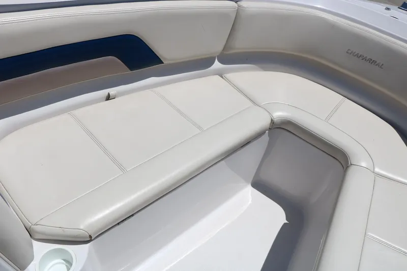 Slide: The Image of 1996 Chaparral 2330 SS boat interior with white cushioned seating. - 19