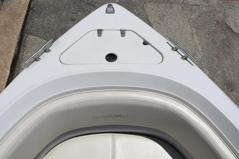 Slide: The Image of Bow view of a 1996 Chaparral 2330 SS boat with white seating and deck. - 21