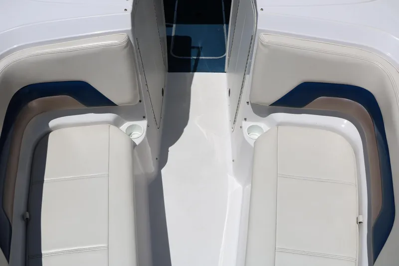 Slide: The Image of Interior seating of a 1996 Chaparral 2330 SS boat, featuring white and blue upholstery. - 23