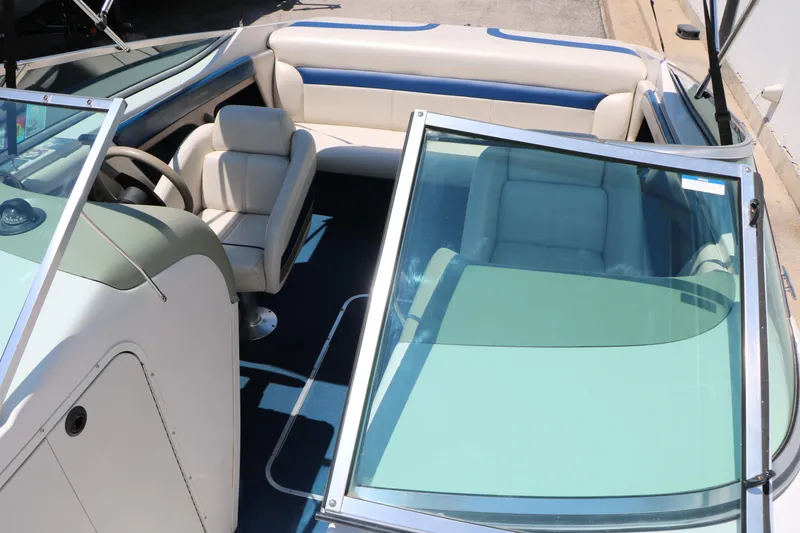 Slide: The Image of 1996 Chaparral 2330 SS boat interior with seating and steering wheel, showcasing sleek design. - 24